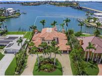 Aerial view of the Mediterranean-style home with lush landscaping, and waterfront access at 3576 San Remo Ter, Sarasota, FL 34239