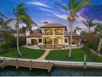 Mediterranean style home featuring a beautiful backyard, swimming pool, dock, and waterfront access at 3576 San Remo Ter, Sarasota, FL 34239
