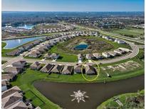 An aerial view showcases this single-Gathering home situated on a lot with a pond in the backyard at 3834 Silver Strand Trl, Palmetto, FL 34221