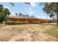 Charming ranch-style home with a covered porch and mature landscaping offering great curb appeal at 5204 24Th E Ave, Palmetto, FL 34221