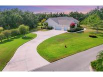 Stunning single-story home featuring a long driveway and lush landscaping, providing excellent curb appeal at 6102 9Th Avenue Cir Ne, Bradenton, FL 34212