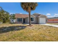 Charming single-story home with attached garage and a palm tree in the front yard at 6503 32Nd W Ave, Bradenton, FL 34209