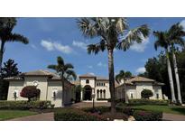 Elegant home showcasing lush landscaping, terracotta tile roof, and classic architectural details at 7104 Teal Creek Gln, Lakewood Ranch, FL 34202