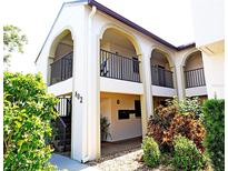 Condo exterior featuring a private balcony, and well maintained landscaping at 802 Capri Isles Blvd # 231, Venice, FL 34292