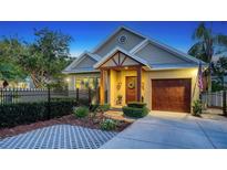 Charming home featuring a manicured front yard, a wooden door with wreath, and a single-car garage at 1934 Bougainvillea St, Sarasota, FL 34239