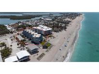 Stunning aerial view of beachside condos with beautiful Gulf views and beachfront access at 2400 N Beach Rd # 1, Englewood, FL 34223
