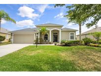 Beautifully landscaped front yard with a well-maintained lawn and charming exterior at 2808 124Th E Ave, Parrish, FL 34219