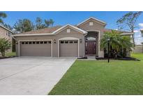 Charming single-story home with a well-manicured lawn and a convenient three-car garage at 4119 101St E Ave, Parrish, FL 34219