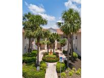 Beautiful courtyard view with a central fountain, palm trees, and well-maintained landscaping in a condominium complex at 4244 Central Sarasota Pkwy # 726, Sarasota, FL 34238