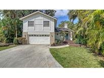 Charming two-story home featuring a well-maintained front yard and attached two car garage at 4514 Trails Dr, Sarasota, FL 34232