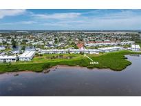 Beautiful aerial view of a waterfront condo community with lush green landscaping and tranquil water features at 4745 Independence Dr # 4745, Bradenton, FL 34210
