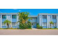 Charming condo building with blue accents and tropical landscaping, offering a serene living environment at 5310 26Th W St # 902, Bradenton, FL 34207