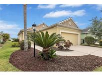 Inviting single-Gathering home featuring beautiful landscaping and an attached two-car garage at 11835 Crawford Parrish Ln, Parrish, FL 34219