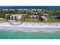 Stunning aerial view of beachfront condos with ocean views and a sparkling pool at 2045 Gulf Of Mexico Dr # M1-302, Longboat Key, FL 34228