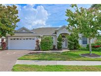 Charming home with manicured lawn, lush landscaping, and attached two-car garage in a serene neighborhood at 3309 45Th E Ave, Bradenton, FL 34203