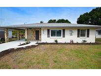 Charming home with stone accents, inviting walkway, fresh landscape and a covered carport at 4506 20Th W St, Bradenton, FL 34207