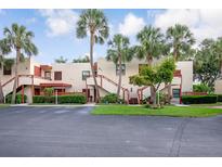 Condo complex boasts lush landscaping with mature palm trees and a well-maintained facade at 523 Spring Lakes Blvd, Bradenton, FL 34210