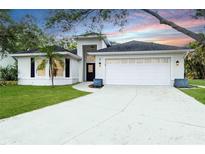 Charming one-story home with a well-maintained lawn and two car garage at 7 Arbor Oaks Dr, Sarasota, FL 34232