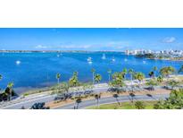 Expansive water view with sailboats on the bay, palm trees lining the shore, and city skyline in the background at 770 Palm Avenue # 903, Sarasota, FL 34236