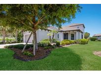 Well-maintained home with lush lawn and beautifully landscaped flower beds at 8191 Gabanna Dr, Sarasota, FL 34231