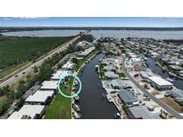 Stunning aerial view of waterfront homes with boat docks and backyard canals, situated in a coastal community at 10423 Waterbird Way # 10423, Bradenton, FL 34209