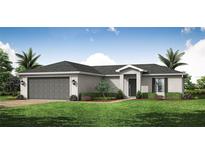 Charming single-story home with a well-maintained lawn and a two-car garage at 1074 Bristol St, Port Charlotte, FL 33952