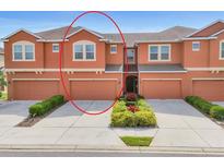 Charming townhome featuring a well-manicured lawn and a two-car garage at 11507 84Th Street E Cir # 102, Parrish, FL 34219