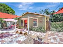 Charming home featuring a brick-paved patio and cozy seating area with colorful accents at 1489 18Th St, Sarasota, FL 34234