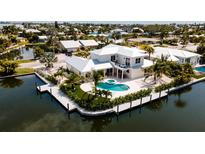 Stunning waterfront property with a private pool and dock, perfect for enjoying coastal living at 603 Emerald Ln, Holmes Beach, FL 34217