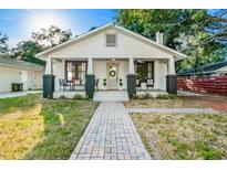 Charming home with inviting front porch, brick pathway and black and white color scheme at 720 37Th W St, Bradenton, FL 34205