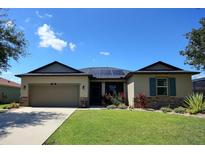 Inviting single-story home featuring a well-manicured lawn, two-car garage, and charming stone accents at 7311 64Th St E, Palmetto, FL 34221