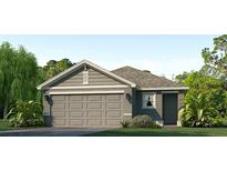 Charming one-story home featuring a gray exterior, two-car garage, and lush landscaping at 12031 Lansing Gln, Parrish, FL 34219