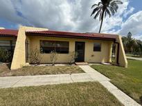 Charming single-story villa with well-kept lawn and sidewalk leading to the front door at 1304 56Th W St, Bradenton, FL 34209