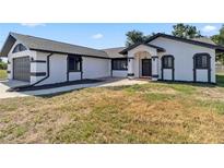 Charming single Gathering home featuring updated paint, manicured lawn, and attached two-car garage at 3239 Daytona Dr, Punta Gorda, FL 33983