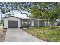 Charming single-story home with brick facade, attached garage, and mature shade tree at 3303 32Nd W St, Bradenton, FL 34205