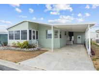 Charming single-story home with a covered carport and well-maintained landscaping, offering curb appeal at 3352 Laurel Oak Way, Sarasota, FL 34237