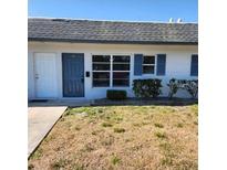 Charming single-story home with a gray roof, blue shutters, and a well-maintained front yard at 4444 Swift Rd # 14, Sarasota, FL 34231