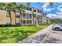 Beautiful condo building with well-maintained landscaping, beige walls, and white balconies at 4802 51St W St # 1711, Bradenton, FL 34210