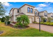 Charming two-story home with a well-manicured lawn and a brick driveway at 5007 Sunnyside Ln, Bradenton, FL 34211