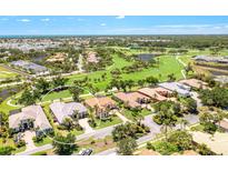 Stunning aerial view of home, showcasing the golf course and lush landscaping at 52 Grande Fairway, Englewood, FL 34223