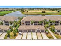 Aerial view of an elegant townhome community, showcasing tile roofs, garages, and golf course views at 5624 Palmer Cir # 101, Bradenton, FL 34211