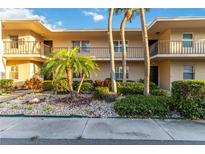 Inviting condo exterior featuring a balcony, lush landscaping, and a well-maintained facade at 6999 W Country Club N Dr # 224, Sarasota, FL 34243