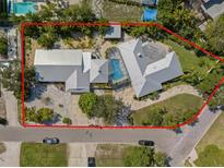 Aerial view of the property featuring a large lot, updated metal roof, and screened-in pool enclosure at 7202 18Th Nw Ave, Bradenton, FL 34209