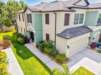Townhome boasts manicured landscaping, a two-car garage, and welcoming front entrance at 7844 52Nd E Ter, Bradenton, FL 34203