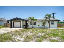 Charming single story home featuring well-maintained landscaping and attached garage at 1227 Porpoise Rd, Venice, FL 34293