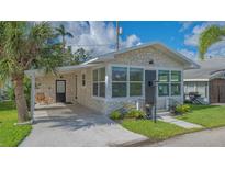 Charming stone house with a convenient carport and well-maintained landscaping, creating inviting curb appeal at 13 Oak St, Bradenton, FL 34208