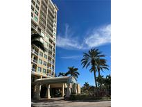 Beautiful condo building exterior with an elegant portico and tropical landscaping at 130 Riviera Dunes Way # 304, Palmetto, FL 34221