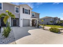 Charming townhome featuring neutral tones, attached garage, and well-maintained landscaping at 1860 Pleasant Maple Ct, Bradenton, FL 34211