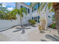 Charming ground-level entrance with manicured landscaping and decorative gravel pathway at 302 And 304 Canal Rd, Sarasota, FL 34242