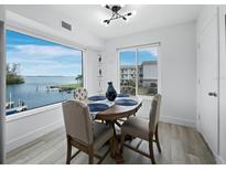 Bright dining room features a water view and a wood table with four chairs at 3320 Gulf Of Mexico Dr # 208C, Longboat Key, FL 34228